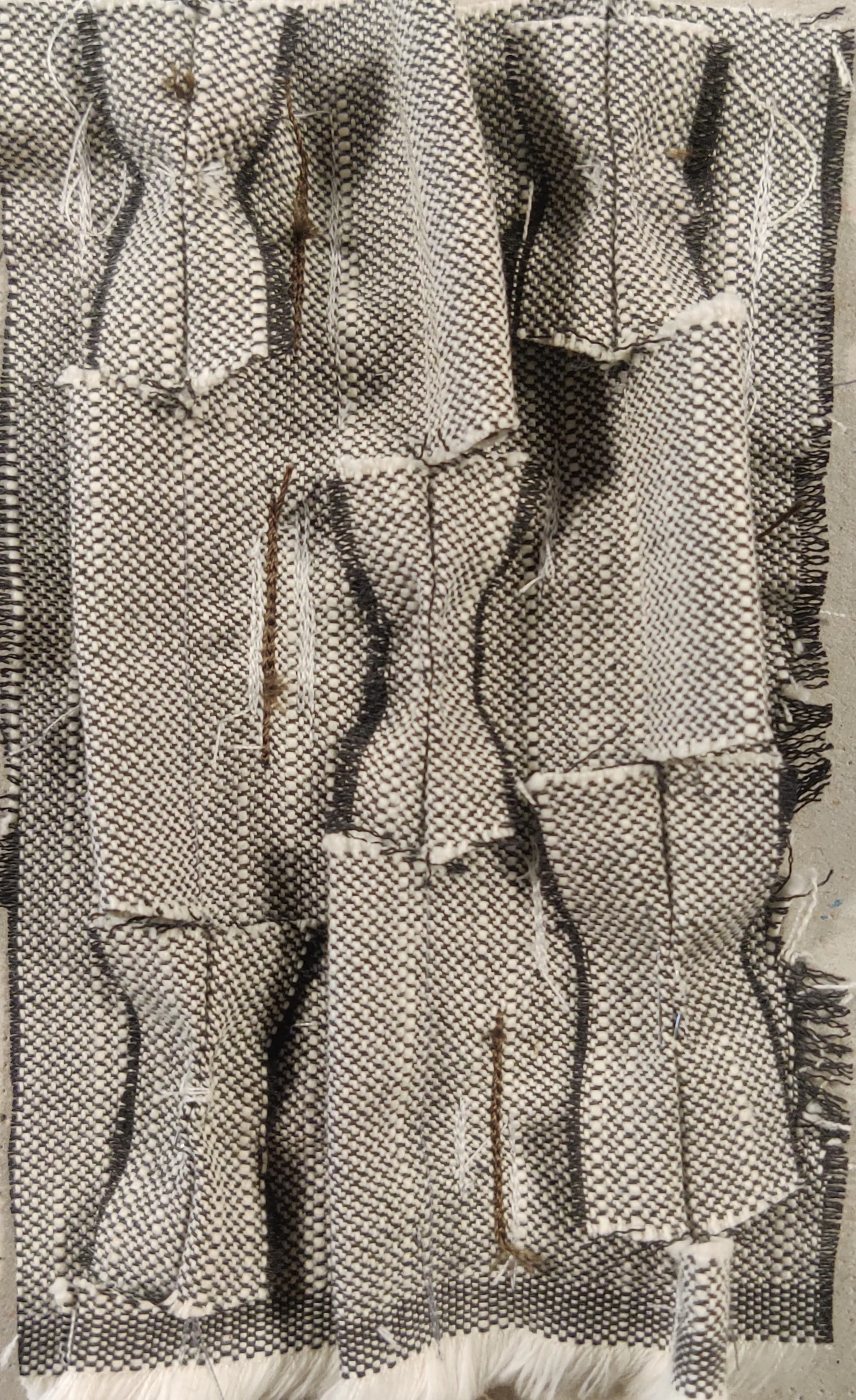 Managerial Grace's manipulated upholstery fabric, stapler-pinned into its woven pattern