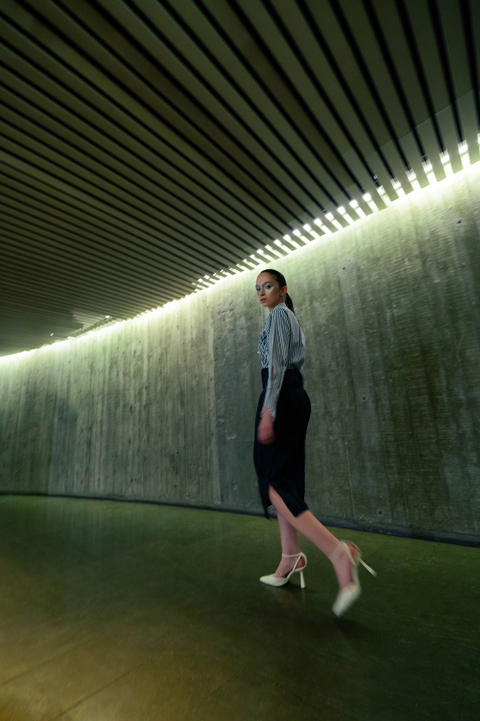 Istituto Marangoni Paris graduate show, July 2023 — The Paralegal Fit walking through the venue's lit corridor
