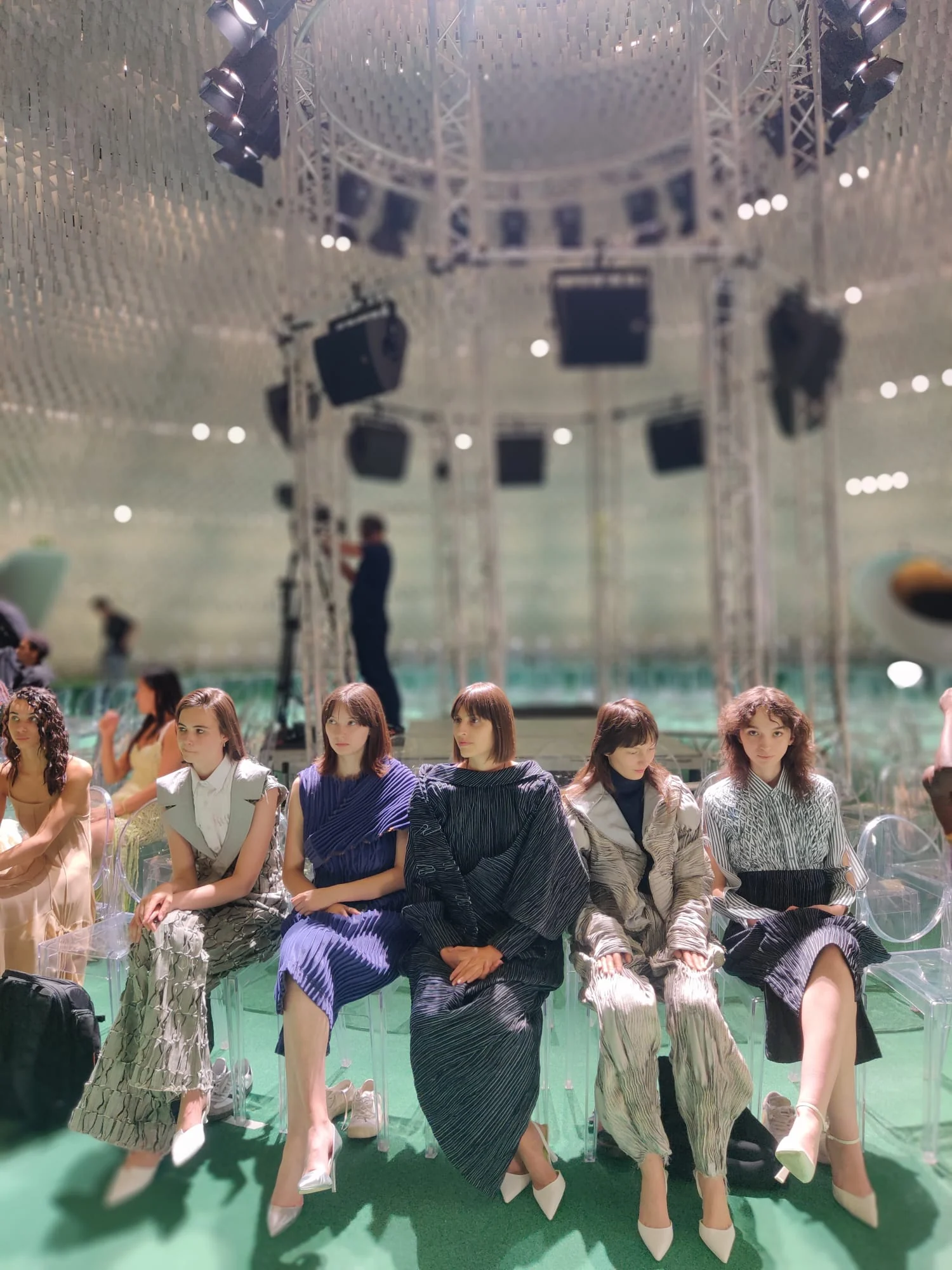Istituto Marangoni Paris graduate show, July 2023 — five looks from the SUIT UP collection seated together beneath the lighting rig at Espace Niemeyer