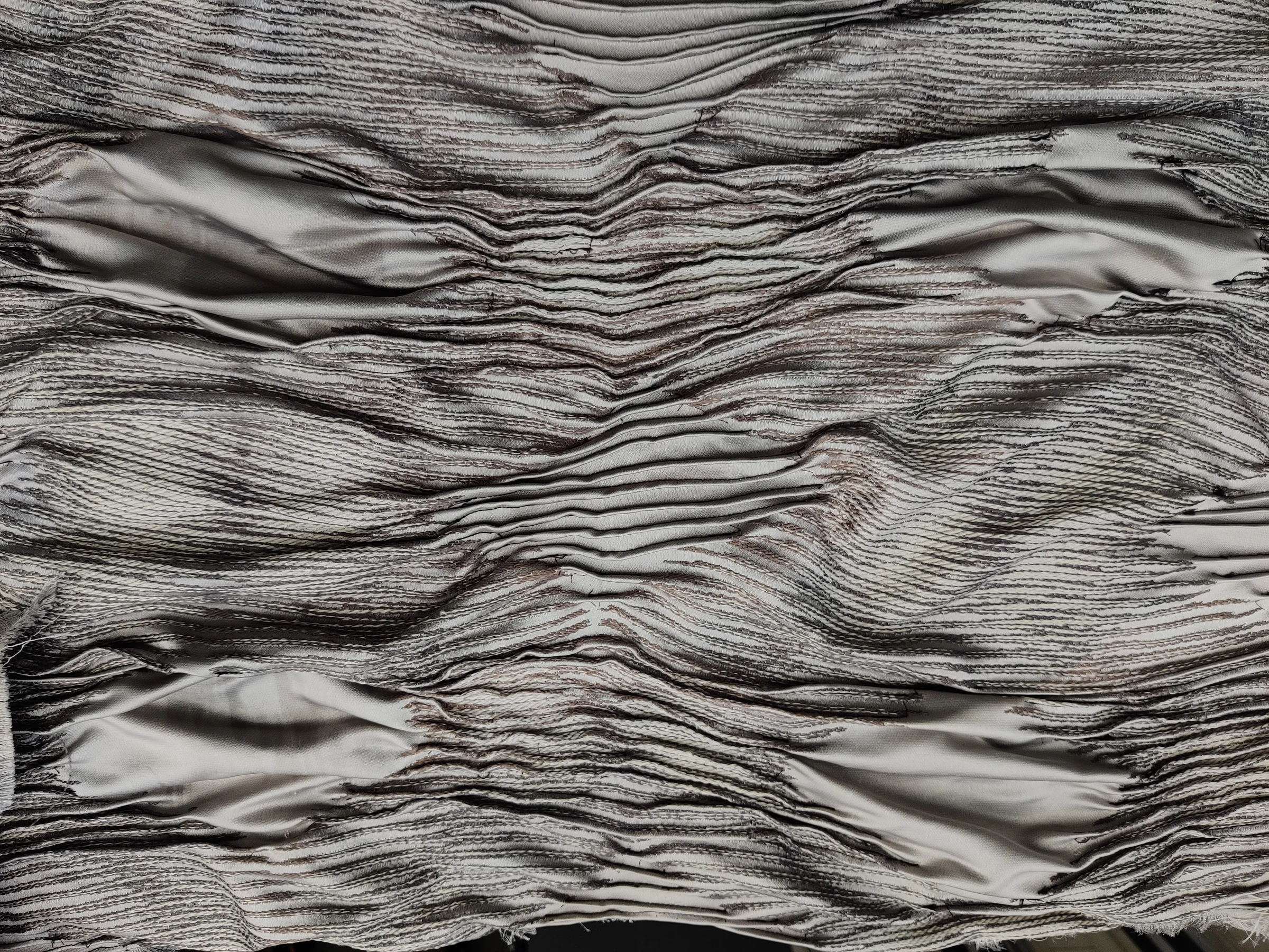 Line sewing technique textile manipulation depicting peaks and lows